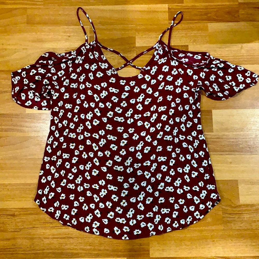 A Maroon shirt with white flowers on it.
